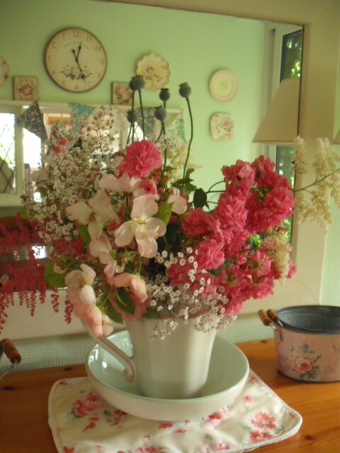 Dorothy Perkins rose, astibles and gypsophila flowers in a jug